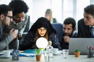 A fortune teller with a glowing crystal ball surrounded by anxious office workers.